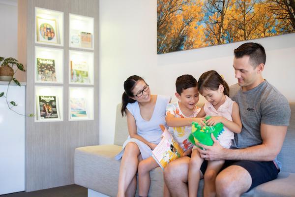 family in dental office waiting room in highgate hill