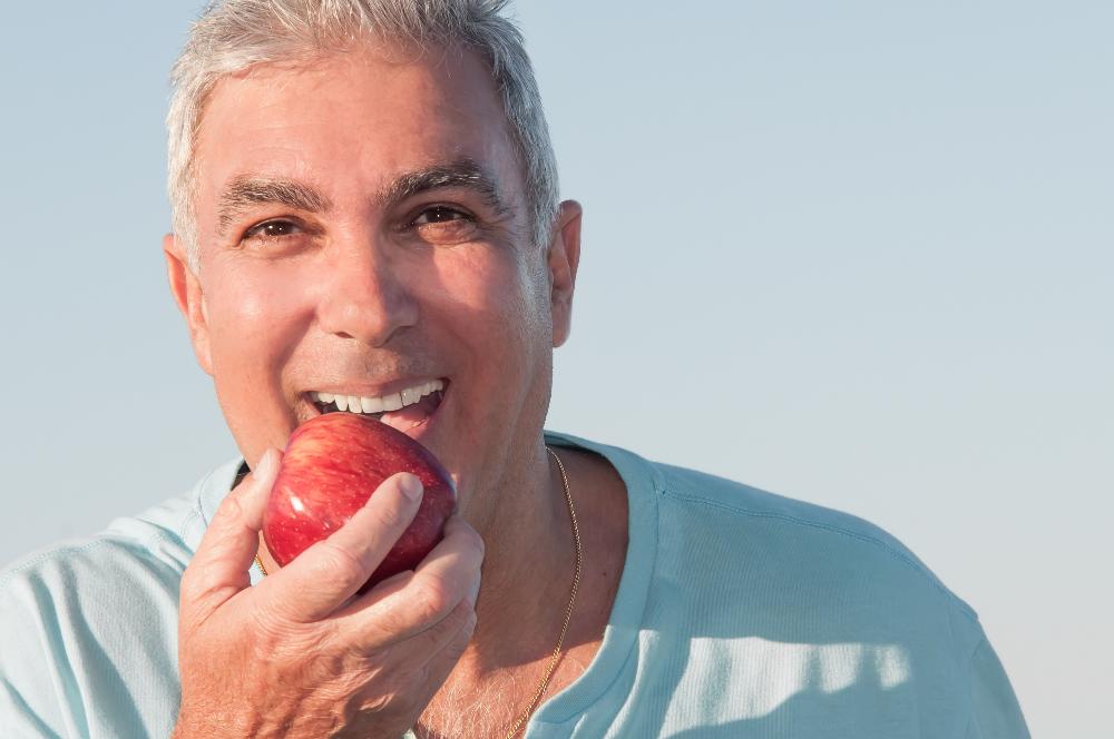 older man with new dental implants in brisbane