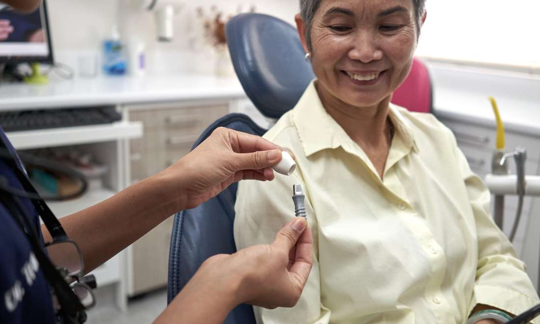 Dr Trang going through implants with a patient